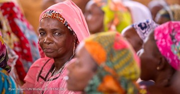 Women wearing brightly coloured headscarves look away from the camera.