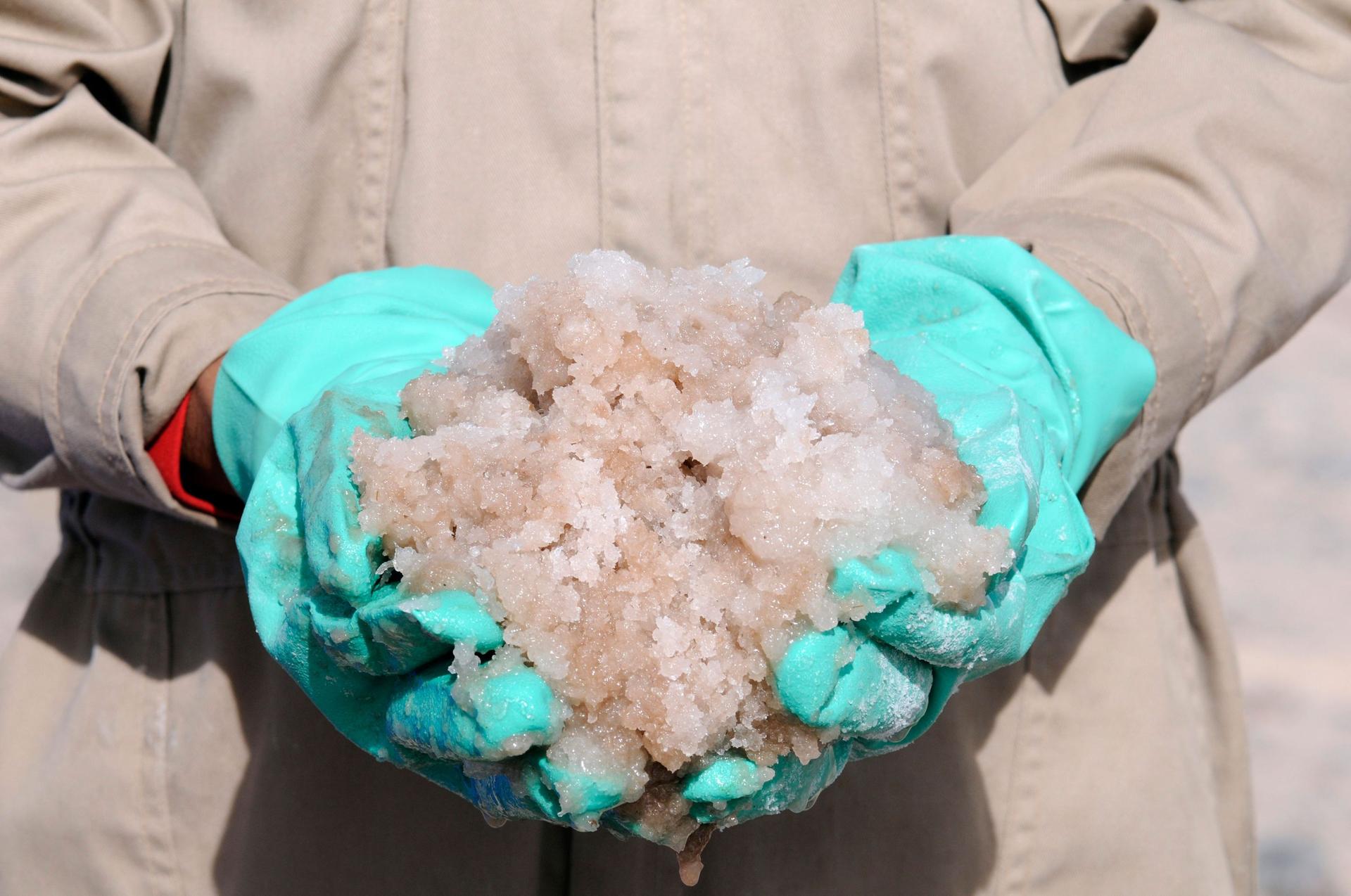 A person holding minerals in their hands