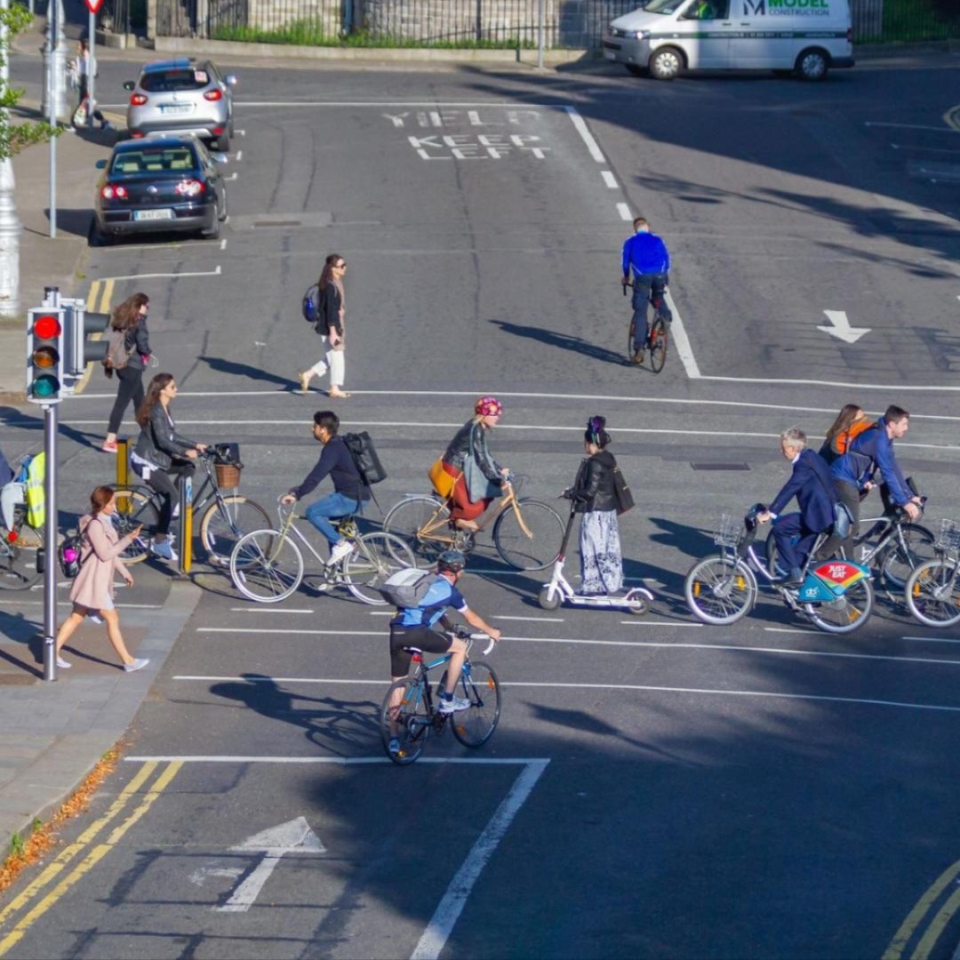 Cyclists and pedestrians on a street in Dublin.