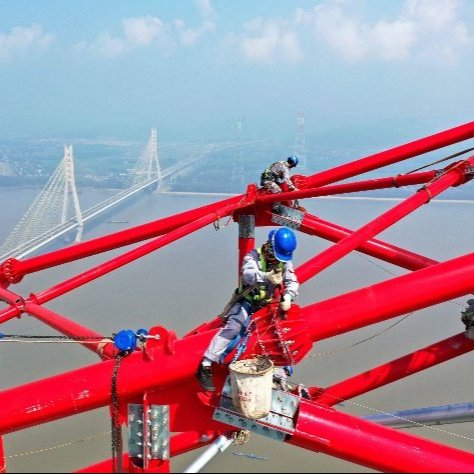 Workers with hard hats on a metal structure