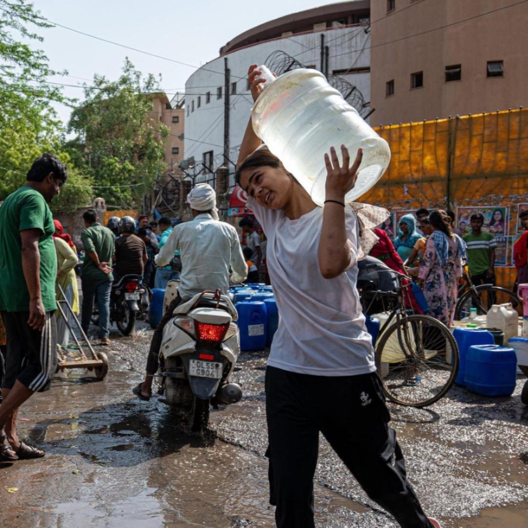 A woman carries water during a blistering hot day in New Delhi, India.